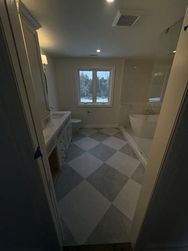 Bathroom with a large checkerboard tile floor in Courtice
