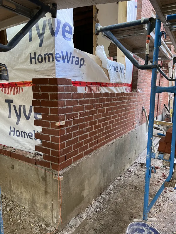 New red brick being toothed into an addition on a Toronto home