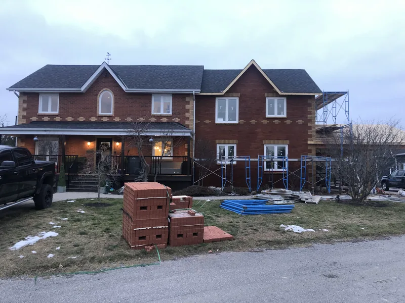 Two storey house re-clad in red brick with buff brick quoins near Enniskillen in Clarington