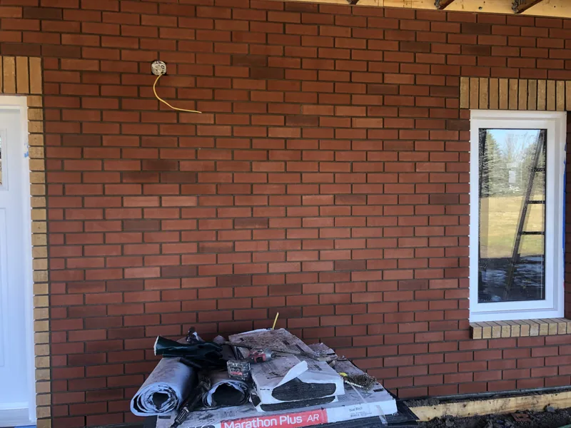 New red brick wall with a buff brick window surround on a Strongback job in nearby Clarington