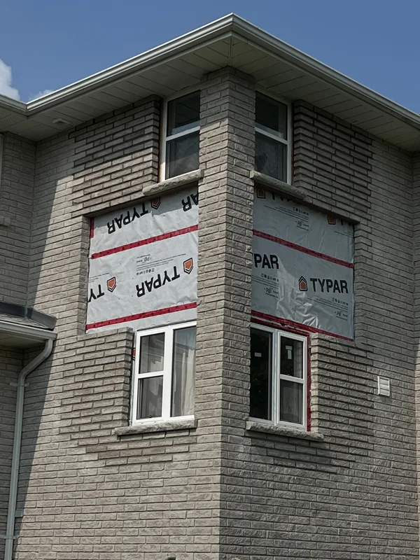 Brick opened up around the windows of a two storey home near Solina in Clarington