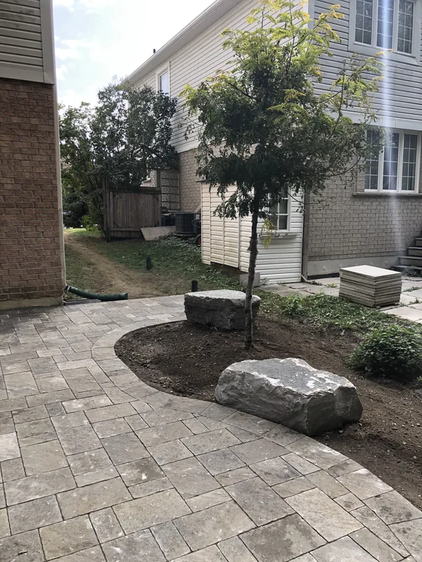 Curved paver walkway lined with armour stone in Whitby