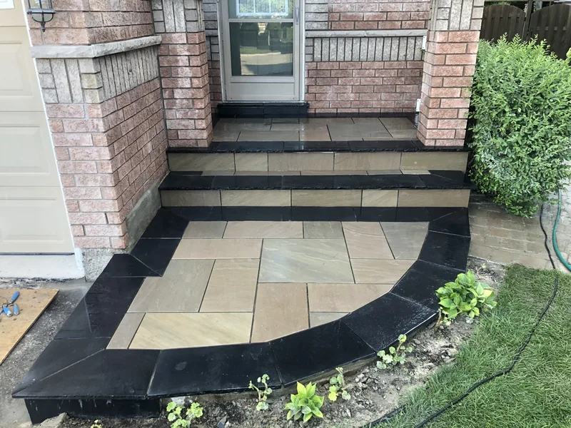 Front porch and steps in flagstone with a black stone border in Pickering