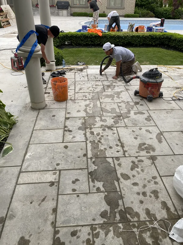 Crew laying a stone pool deck in Whitby