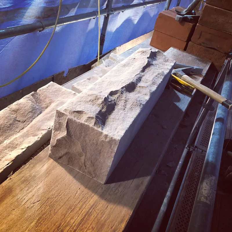 New cut stone sill being set on a Toronto restoration