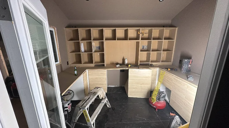Built-in office desks and cubby shelving during installation