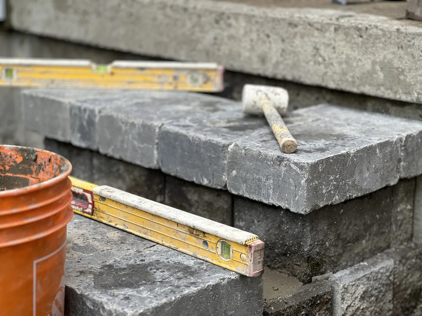 Stone caps being set on a block wall in Whitby