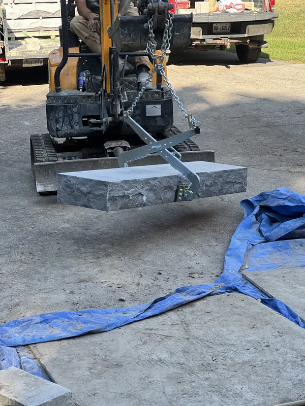 Solid stone step slab being set by machine on an Oshawa job