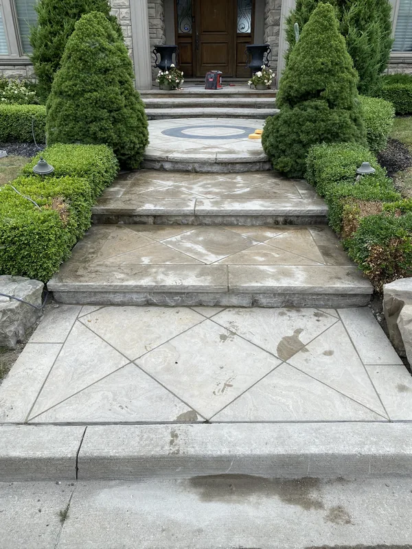 Natural stone front walkway and steps with a circular inlay in Whitby