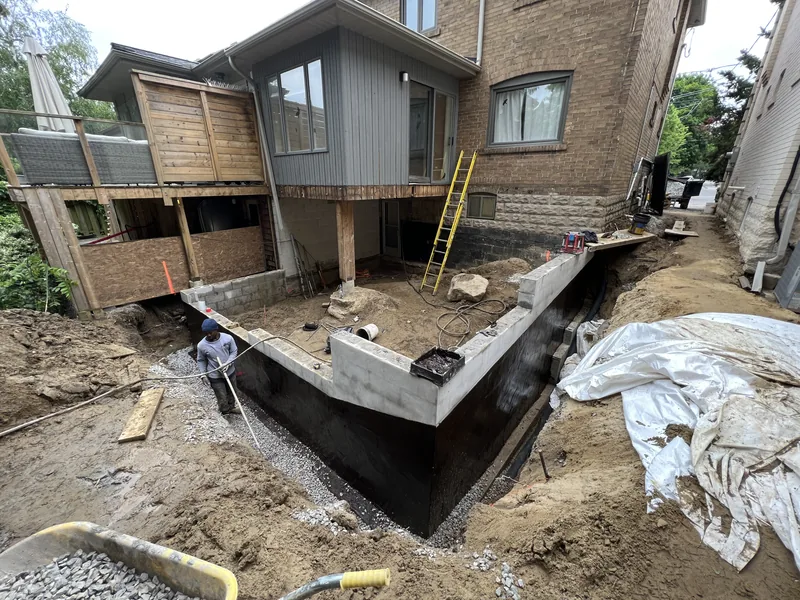Black waterproofing membrane on a new foundation in Toronto
