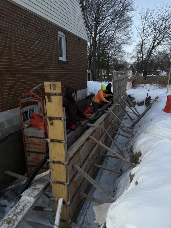 Foundation wall forms set and poured in winter in Toronto